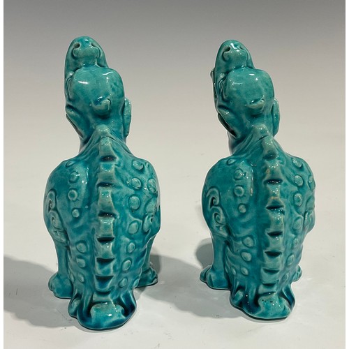 59 - A pair of Burmantofts Faience models, of dragon type mythical beasts, glazed throughout in turquoise... 