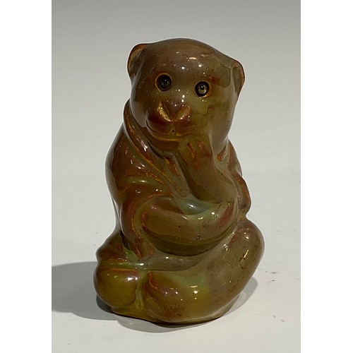 36 - A Burmantofts Faience model, of a seated robed monkey, glazed in mottled tones of bronze lustre, gla... 
