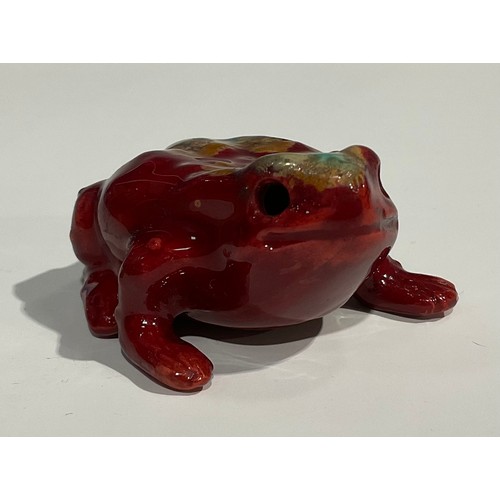 19 - A Bernard Moore flambé model, of a toad, speckled with tones of orange and turquoise, 5.5cm long, si... 