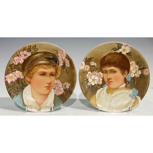 57 - A pair of Aesthetic Movement circular plates, painted by Mary Salisbury, with portraits of a Victori... 