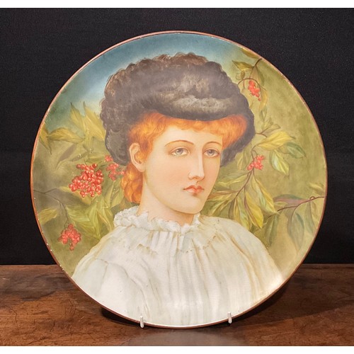 80 - An Aesthetic Movement circular charger, Study of a Girl, painted with a portrait of an auburn-haired... 