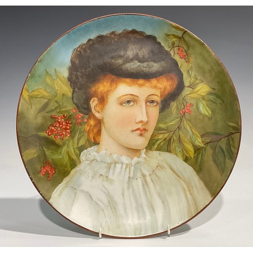 80 - An Aesthetic Movement circular charger, Study of a Girl, painted with a portrait of an auburn-haired... 