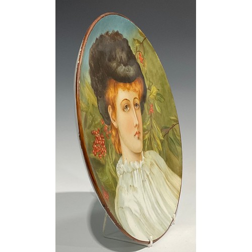 80 - An Aesthetic Movement circular charger, Study of a Girl, painted with a portrait of an auburn-haired... 