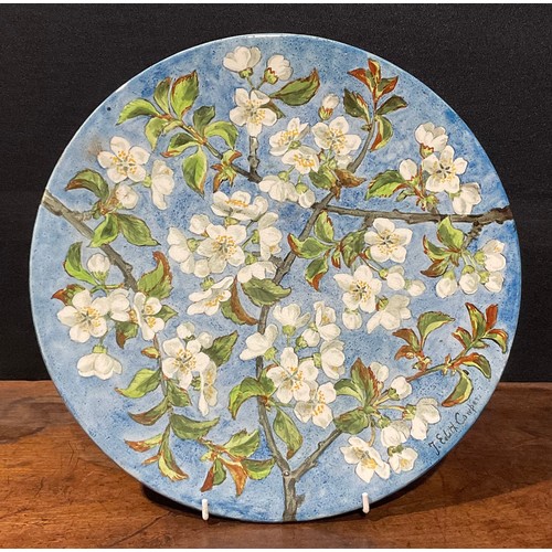 72 - An Aesthetic Movement circular charger, painted by J Edith Cowper, signed, with cherry blossom on a ... 