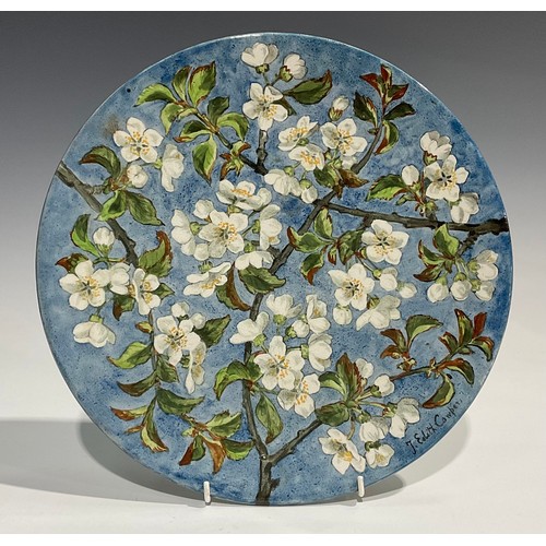 72 - An Aesthetic Movement circular charger, painted by J Edith Cowper, signed, with cherry blossom on a ... 