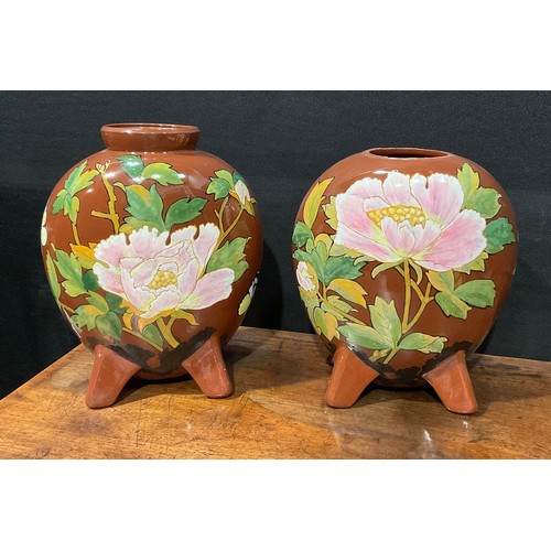 61 - A pair of Minton's Art Pottery Studio, Kensington Gore, moon flask vases, painted in polychrome with... 