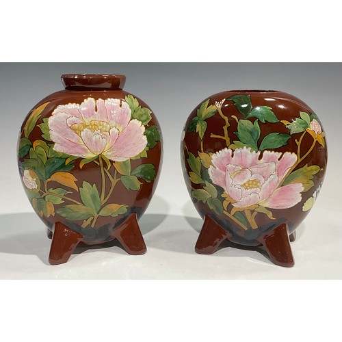 61 - A pair of Minton's Art Pottery Studio, Kensington Gore, moon flask vases, painted in polychrome with... 