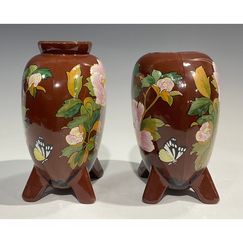 61 - A pair of Minton's Art Pottery Studio, Kensington Gore, moon flask vases, painted in polychrome with... 