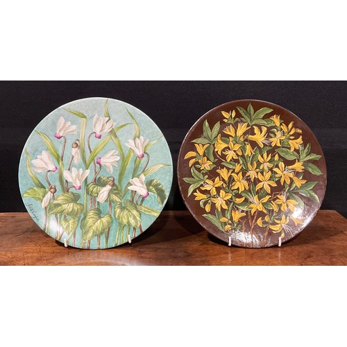 74 - An Aesthetic Movement circular charger, painted by J Edith Cowper, signed, with yellow alstroemerias... 