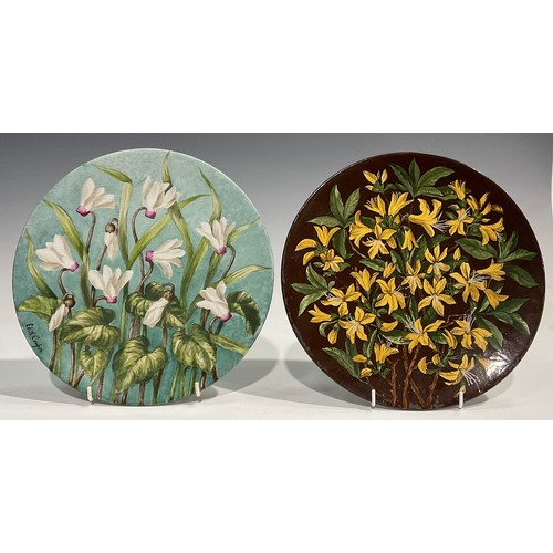 74 - An Aesthetic Movement circular charger, painted by J Edith Cowper, signed, with yellow alstroemerias... 