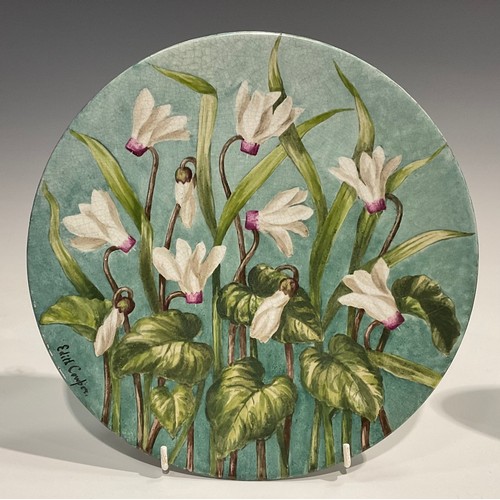 74 - An Aesthetic Movement circular charger, painted by J Edith Cowper, signed, with yellow alstroemerias... 