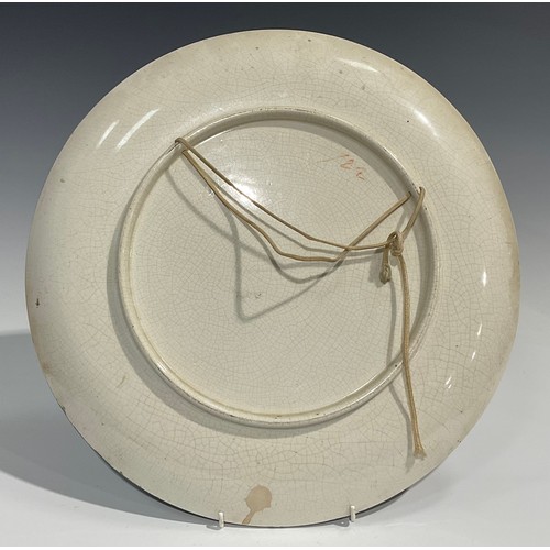 70 - An Aesthetic Movement circular charger, painted by F Cridland, signed and dated March 10th 1882, wit... 