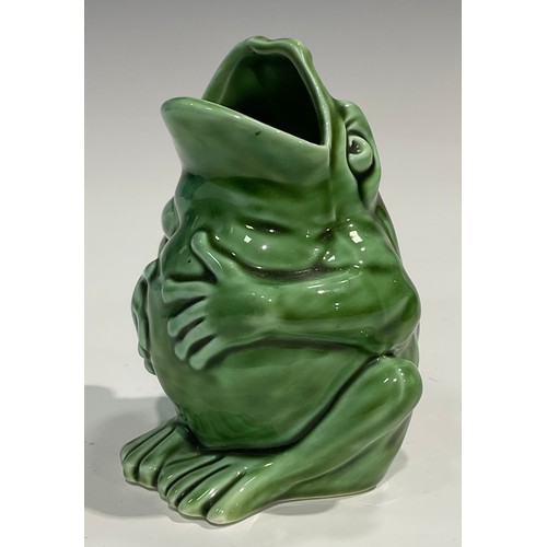 45 - A Burmantofts style spoon warmer, as a grotesque seated toad, glazed throughout olive green, 13cm hi... 