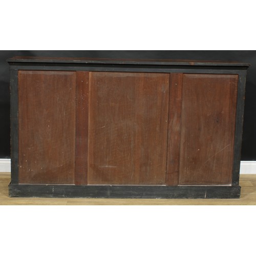 2292 - A Victorian walnut low library bookcase, slightly oversailing top with moulded edge above a glazed d... 