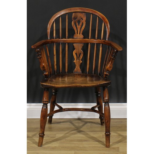 1852 - A near pair of 19th century yew and elm Windsor elbow chairs, each with a low hoop back, shaped and ... 