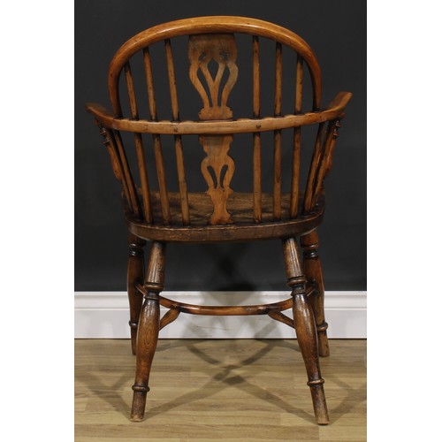 1852 - A near pair of 19th century yew and elm Windsor elbow chairs, each with a low hoop back, shaped and ... 