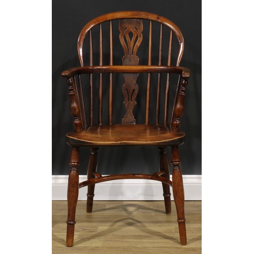 1852 - A near pair of 19th century yew and elm Windsor elbow chairs, each with a low hoop back, shaped and ... 