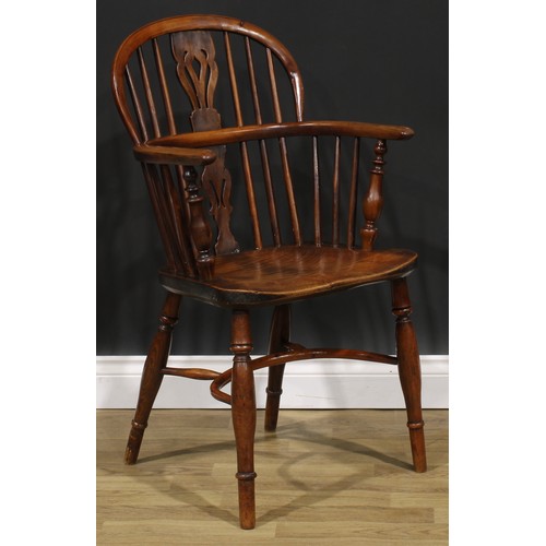 1852 - A near pair of 19th century yew and elm Windsor elbow chairs, each with a low hoop back, shaped and ... 