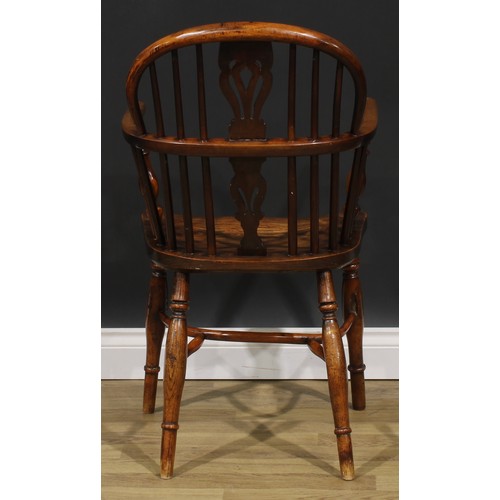 1852 - A near pair of 19th century yew and elm Windsor elbow chairs, each with a low hoop back, shaped and ... 