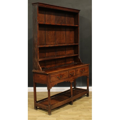 2119 - A George III oak potboard dresser, moulded cornice above three plate rack shelves, the projecting ba... 