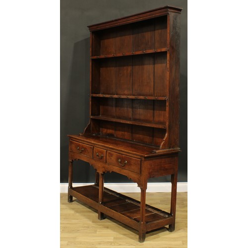 2119 - A George III oak potboard dresser, moulded cornice above three plate rack shelves, the projecting ba... 