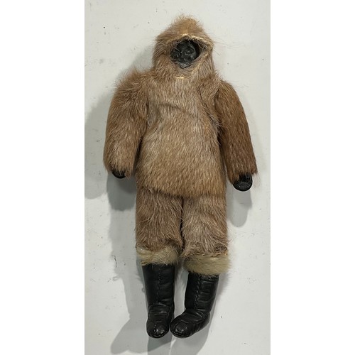 2638 - An Alaskan Inuit doll, carved soapstone head, seal skin clothes, leather boots and gloves, 28cm high