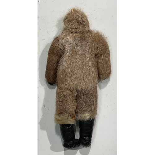 2638 - An Alaskan Inuit doll, carved soapstone head, seal skin clothes, leather boots and gloves, 28cm high