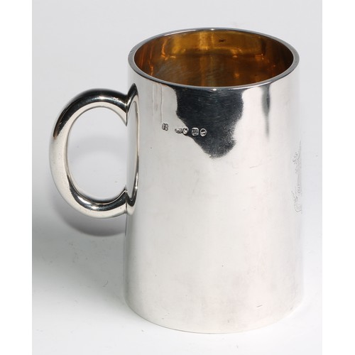 1105 - A Victorian silver spreading cylindrical pint mug,  glass base, gilt interior, engraved heraldry and... 