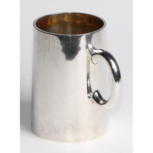 1105 - A Victorian silver spreading cylindrical pint mug,  glass base, gilt interior, engraved heraldry and... 