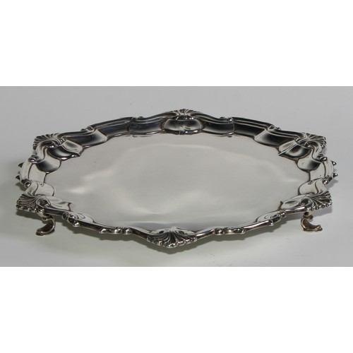 1103 - A Victorian silver shaped circular salver, of George II design, plain field, hoof feet, 24cm diam, W... 