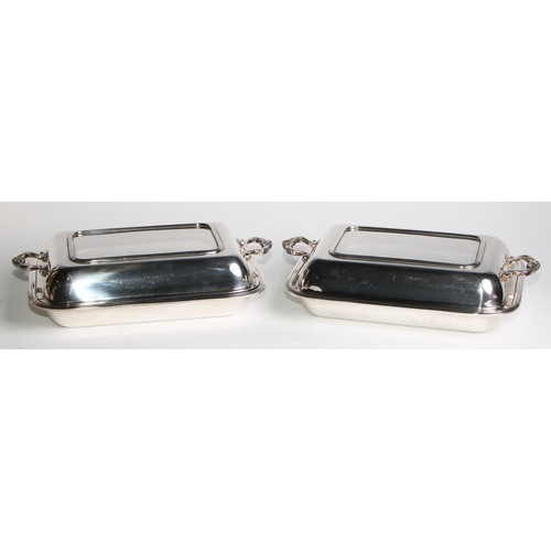 820 - A pair of early 20th century E.P.N.S rounded rectangular entree dishes, 33cm wide, Adie Brothers Ltd... 