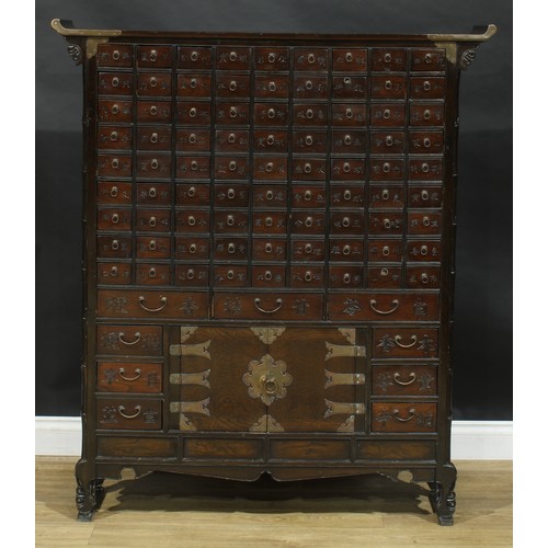 1649 - A Chinese hardwood apothecary chest, pagoda top above eighty-one small drawers and nine further draw... 