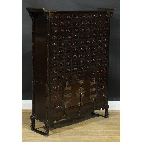 1649 - A Chinese hardwood apothecary chest, pagoda top above eighty-one small drawers and nine further draw... 