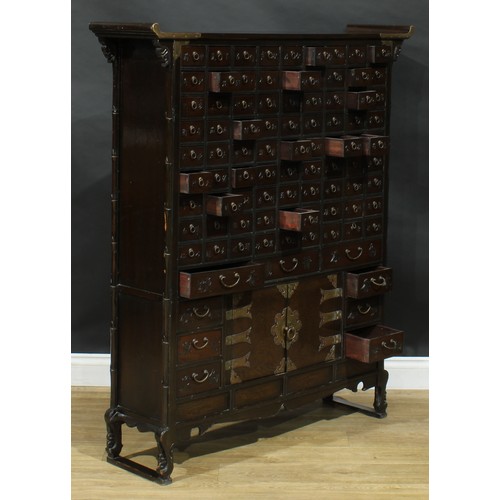 1649 - A Chinese hardwood apothecary chest, pagoda top above eighty-one small drawers and nine further draw... 