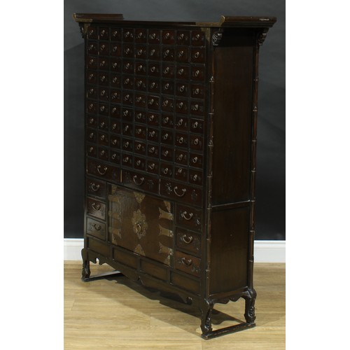 1649 - A Chinese hardwood apothecary chest, pagoda top above eighty-one small drawers and nine further draw... 