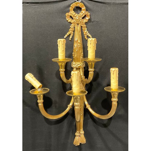 2019 - A harlequin garniature of Louis XVI style brass five-light wall sconces, ribbon crestings, the large... 