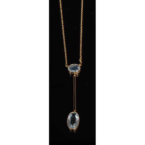 1501 - An Art Deco style aquamarine pendant, stamped '15ct', the larger oval facet cut stone suspended from... 