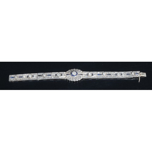 1500 - An Art Deco diamond and sapphire panel bracelet in the manner of Cartier, each panel centered with a... 