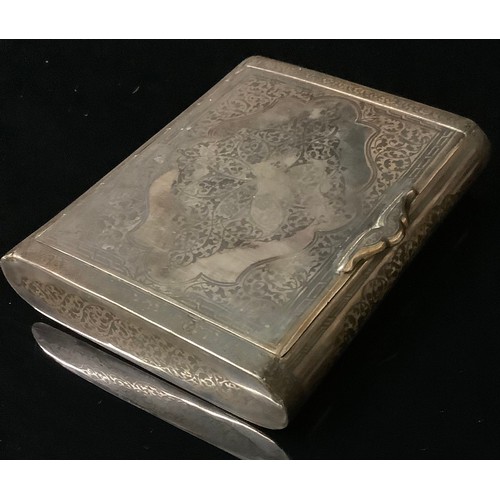 2277 - An eastern silver coloured metal and niello bowed rectangular cigarette case, decorated overall with... 