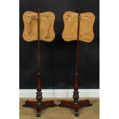 2540 - A pair of William IV rosewood and mahogany pole screens, each with a shaped rectangular needwork ban... 