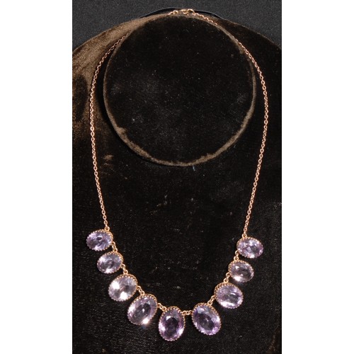 1339 - A 9ct rose gold and amethyst necklace and earring suite, the necklace set with nine graduated oval f... 