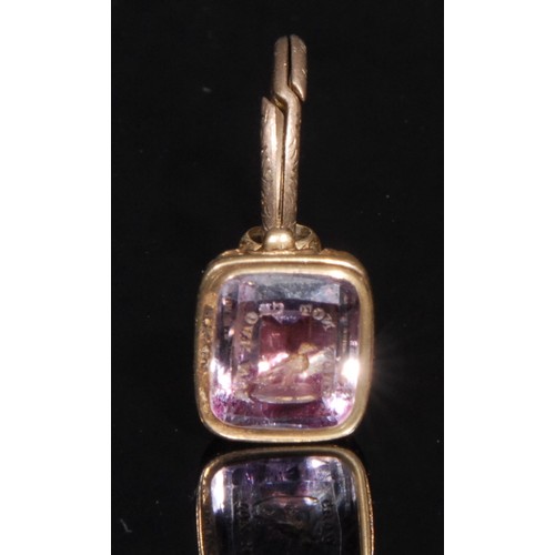 1402 - A late 19th century gold coloured metal and amethyst seal fob, carved in reverse with the motto of t... 