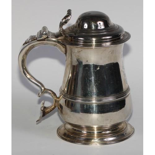 898 - A George II silver bell shaped tankard, hinged domed cover with scroll thumbpiece, S-scroll handle w... 