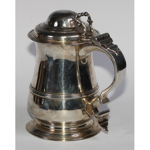 898 - A George II silver bell shaped tankard, hinged domed cover with scroll thumbpiece, S-scroll handle w... 