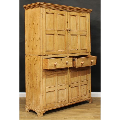 1718 - A 19th century pine servants' quarters livery or housekeeper’s cupboard, moulded cornice above a pai... 