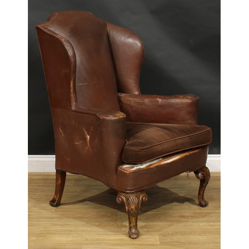 1737 - A George II Revival leather wing chair, in the Irish taste, stuffed-over upholstery, squab cushion, ... 