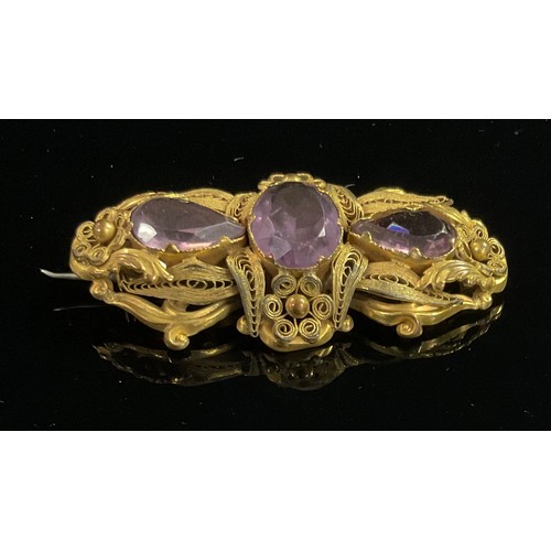 1318 - A 19th century pale purple amethyst and gilt metal bracelet, set with one large and seven smaller ov... 