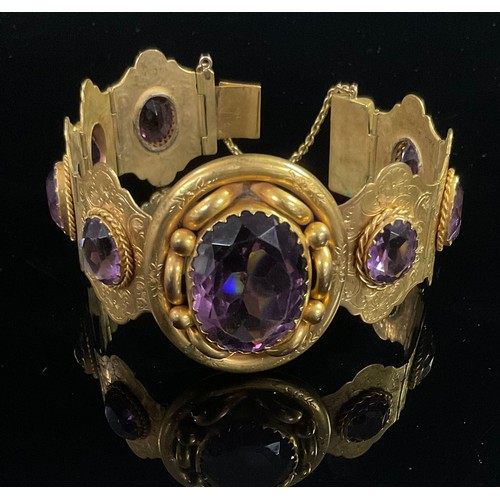 1318 - A 19th century pale purple amethyst and gilt metal bracelet, set with one large and seven smaller ov... 