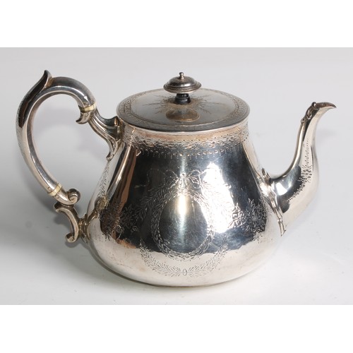 1106 - A Victorian silver teapot, bright-cut engraved and outlined with wrigglework, vacant ribbon-crested ... 