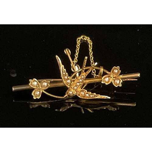 1507 - An Edwardian Art Nouveau seed pearl set pendant brooch, stamped '15ct', the stylised flowerheads wit... 